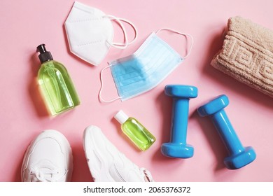 Disposable Face Mask, Respirator, Sport Sneakers, Dumbbells, Sanitizer Bottle And Towel. Gym During Coronavirus COVID-19 Pandemic. Post Covid Recovery