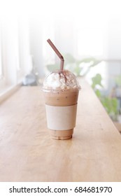 Disposable Iced Coffee Cup On Wooden Table With Coffee Shop Background.