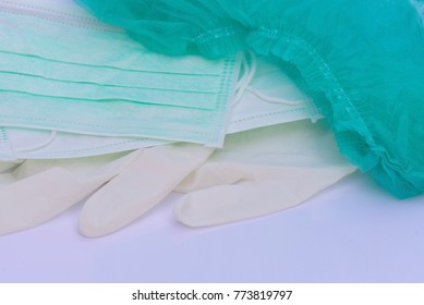 Disposable Medical White Gloves, Medical Cap And Mask On White Background.Medical Equipment Concept.