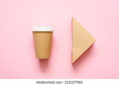 Disposable paper cup and triangular sandwich container on a pink background.