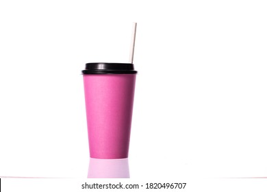 Disposable pink coffee cup with paper straw isolated on white background. Coffee to go, takeaway hot drinks, hen party, restaurant, catering business concept, mockup template for cafe. Copy space