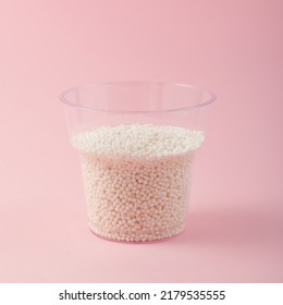 Disposable Plastic Cup With Tapioca Pearl On Pink Background. White Sago Pearls. Tapioca Ball For Bubble Tea Or Boba Drink.