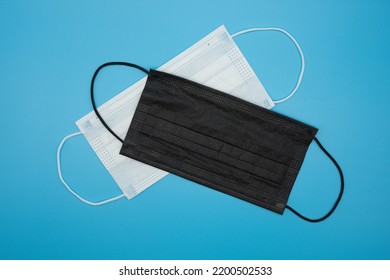 Disposable Protective Masks Of Various Colors On A Blue Background