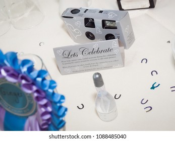 Disposable Silver Wedding Camera On A Wedding Table.