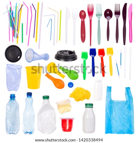 Disposable single use plastic objects such as bottles, cups, forks, spoons and drinking straws that cause pollution of the environment, especially oceans. Isolated on white background.