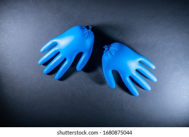 Disposable Surgical Gloves, Flat-lay. Corona Virus Concept. Medical Blue Glowes, Isolated On Dark Gray