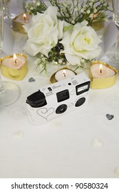 Disposable White Wedding Camera On A Wedding Table.