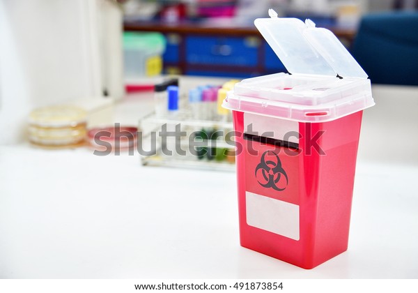 Disposal container for Infectious waste,\
reducing medical waste disposal. Small Medical Waste sharps\
container with sharps for\
bio-hazard.