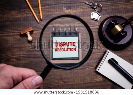 Dispute resolution. Lawyers, litigation, law and justice concept. Man's hand, holding magnifying glass