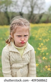 Dissapointed Kid Girl At A Meadow