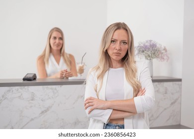 Dissatisfied client stands at the reception of a beauty salon. 