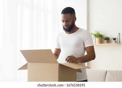 Dissatisfied Online Shopper. Sad African American Millennial Guy Received Wrong Order