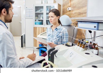 Dissatisfied Patient Reading Paper With Prescriptions Of Doctor And Listening To His Advice