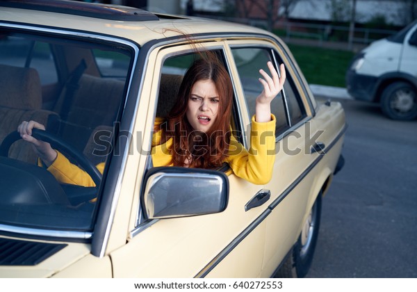 Dissatisfied woman in the car behind the wheel          \
                   \
