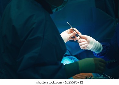 Dissection Forceps Or Hemostatic Forceps Passing In Surgeon Hand By Team Surgeons In Surgery Center For Interventions With Instruments In Surgeon Operation Electrosurgery With Thoracotomy Microsurgery