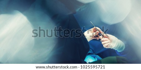 Dissection forceps or hemostatic forceps passing in surgeon hand by team surgeons in surgery center for interventions with instruments in surgeon operation electrosurgery with thoracotomy microsurgery