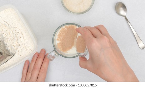 Dissolving Dry Yeast In Warm Milk. Step By Step Flat Bread Recipe, Baking Process. Close Up View From Above, Woman Hands