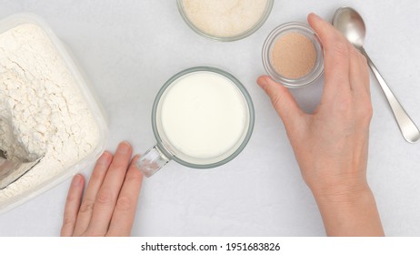 Dissolving Dry Yeast In Warm Milk. Step By Step Flat Bread Recipe, Baking Process. Close Up View From Above, Woman Hands