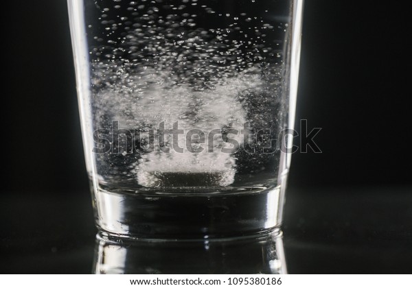 dissolving\
effervescent tablet in a glass of\
water