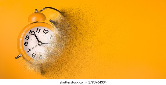 Dissolving orange alarm clock. Dissolving time - Shutterstock ID 1793964334