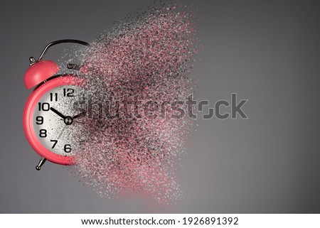 Dissolving pink  alarm clock. Dissolving time