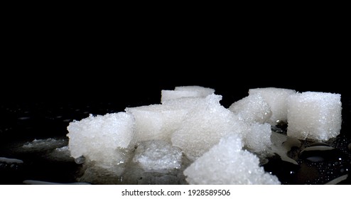 Dissolving Sweet Sugar Pieces In Water. Concept Of Chemical Industry. Manufacture Of Plastics, Pharmaceuticals, Effervescent Drinks And Frozen Foods. Close Up. High Quality Photo.