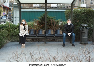 Distance Between A Man And A Woman At A Bus Stop During A Coronavirus Epidemic. Covid 19.