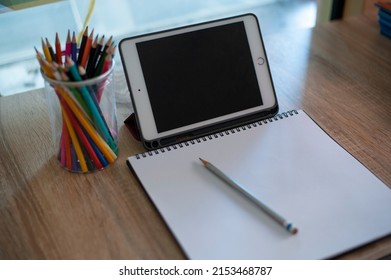 Distance Education Concept. Above Top View Of Female Student Sitting At Desk, Writing In Notebook, Taking Notes, Using Laptop, Having Online Class With Teacher. Remote Studying From Home, Quarantine