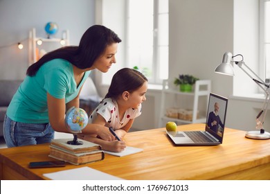 Distance Education. Mother And Daughter Watching Online Video Conference With Mature Teacher On Laptop At Home