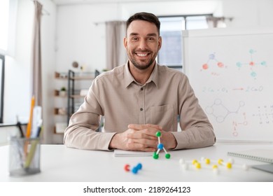 distance education, school and remote job concept - happy smiling male chemistry teacher with molecular model having online class at home office - Powered by Shutterstock