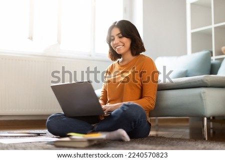 Distance Learning. Happy Young Middle Eastern Female Study With Laptop At Home, Cheerful Arab Woman Sitting On Floor With Computer In Living Room, Enjoying Online Education, Copy Space