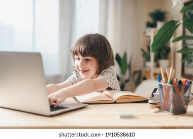 Distance Learning Online Education. Caucasian Smile Kid Boy Studying At Home With Laptop And Doing School Homework. Thinking Child Siting At Table With Notebook. Back To School.