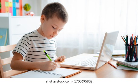 Distance Learning Online Education. A Schoolboy Boy Studies At Home And Does School Homework. A Home Distance Learning.