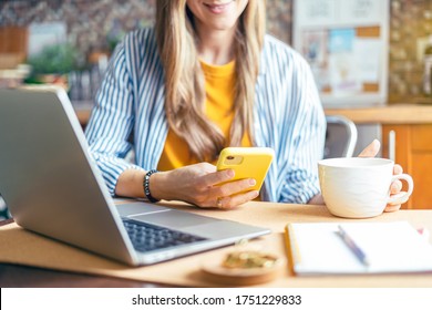 Distance Learning Online Education And Work. Business Woman Having A Facetime Video Call. Happy And Smiling Girl Working From Home Office Kithcen And Drinking Coffee. Using Laptop And Mobile Phone