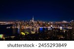 Distancing from a spectacular view of New York, the USA on the waterfront of the East River. Skyline of metropolis at night. Aerial perspective.