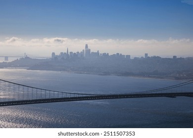 Distant buildings of San Francisco skyline and bridge span on sunny day - Powered by Shutterstock