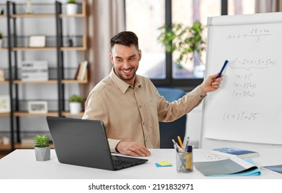 Distant Education, School And Remote Job Concept - Happy Smiling Male Math Teacher With Laptop Compute Showing Equation On Flip Chart Having Online Class Or Video Call At Home Office