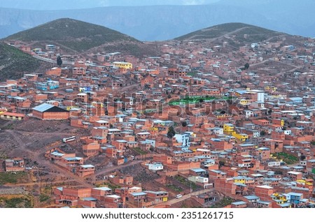 Distant high view of Potosi city. Colorful neighborhoods, houses and rooftops in a city exploited by the mining system for centuries, living in poverty. Bolivia. Southamerica