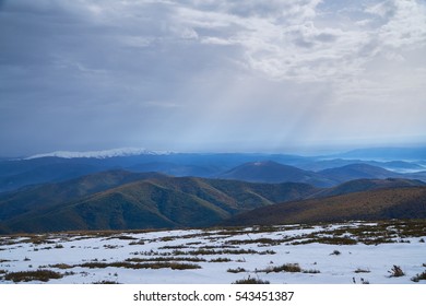  Distant mountain range and thin layer of clouds on the valleys - Misty mountains in the morning.                              