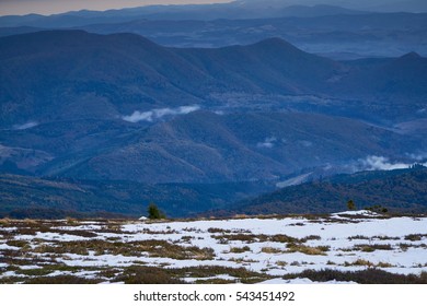  Distant mountain range and thin layer of clouds on the valleys - Misty mountains in the morning.                              