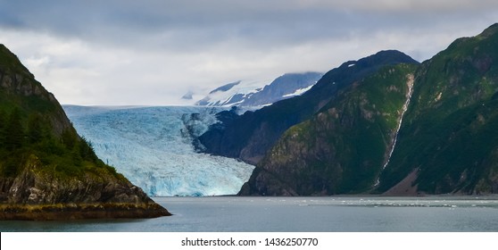Distant panoramic view of a Holgate glacier with waterfall on the side in Kenai fjords National Park, Seward, Alaska, United States, North America