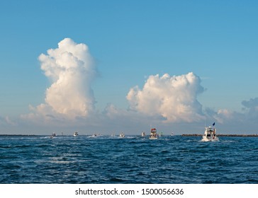 Distant Trees Along The Shoreline With A Lake In The Front And Clouds Along The Treeline