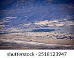 A distant view of the green oasis of Furnace Creek Ranch in Death Valley, California, as seen from the heights of Aguereberry Point.