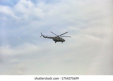 Distant view of military helicopter flying in sky