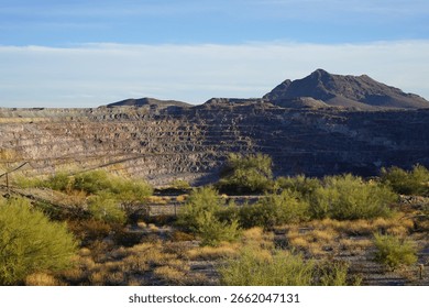 Distant view of the New Cornelia Mine, an abandoned open-pit copper mine in southern Arizona desert, at sunset