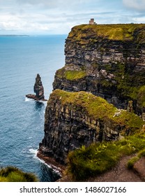 A distant view of O'Brien's Tower, located in the Cliffs of Moher, located at the southwestern edge of the Burren region in County Clare, Ireland