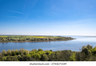 Distant view with rapeseed field and wind generators