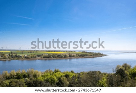 Distant view with rapeseed field and wind generators