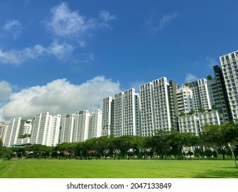 Distant View Of Residential Apartment (HDB) With Empty Field Under Cloudy Sky