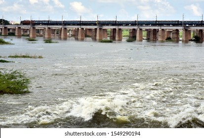 distant view of train crossing a river over a bridge
